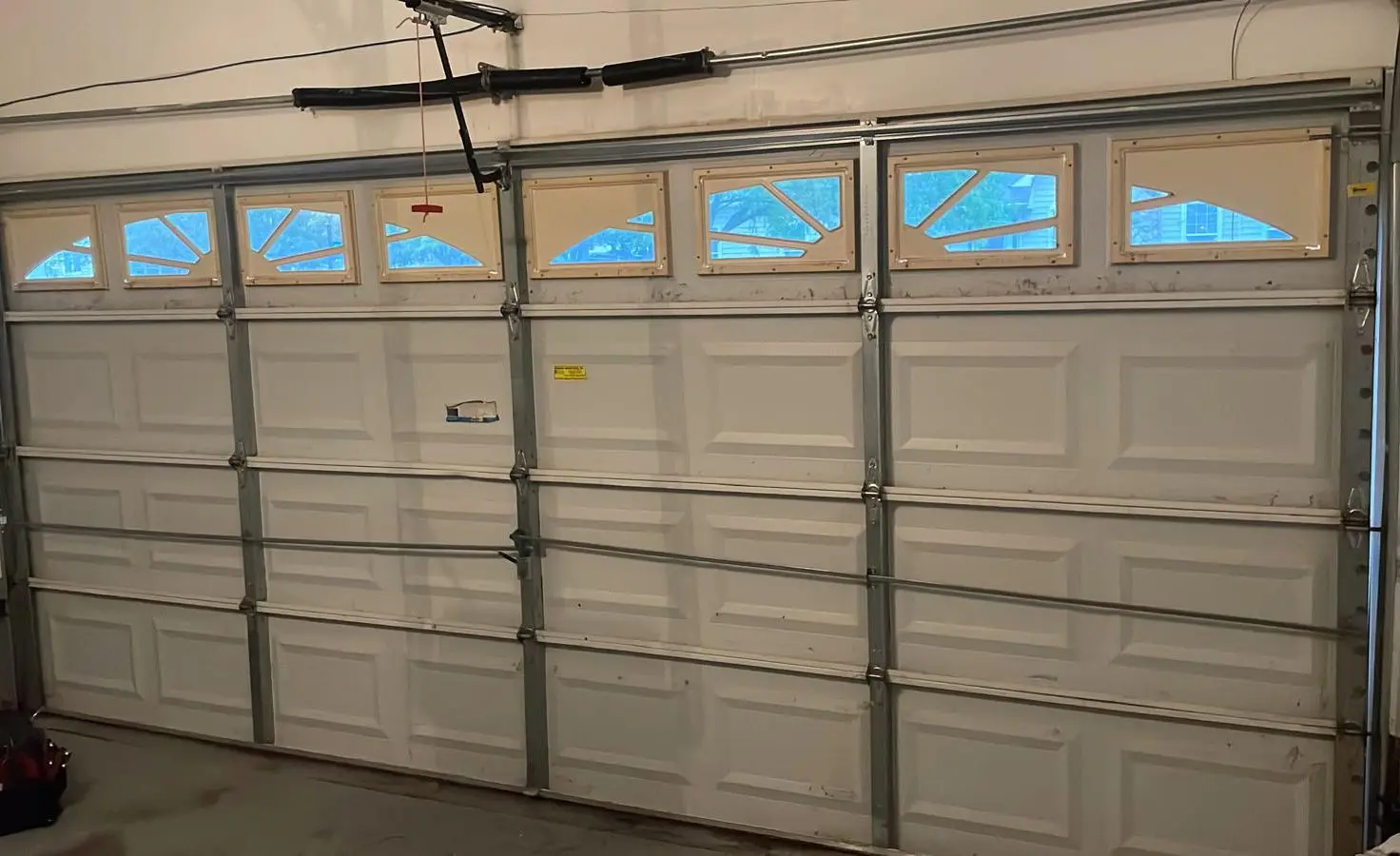 Skilled garage door technician from Bloomfield, CT performing a detailed safety inspection