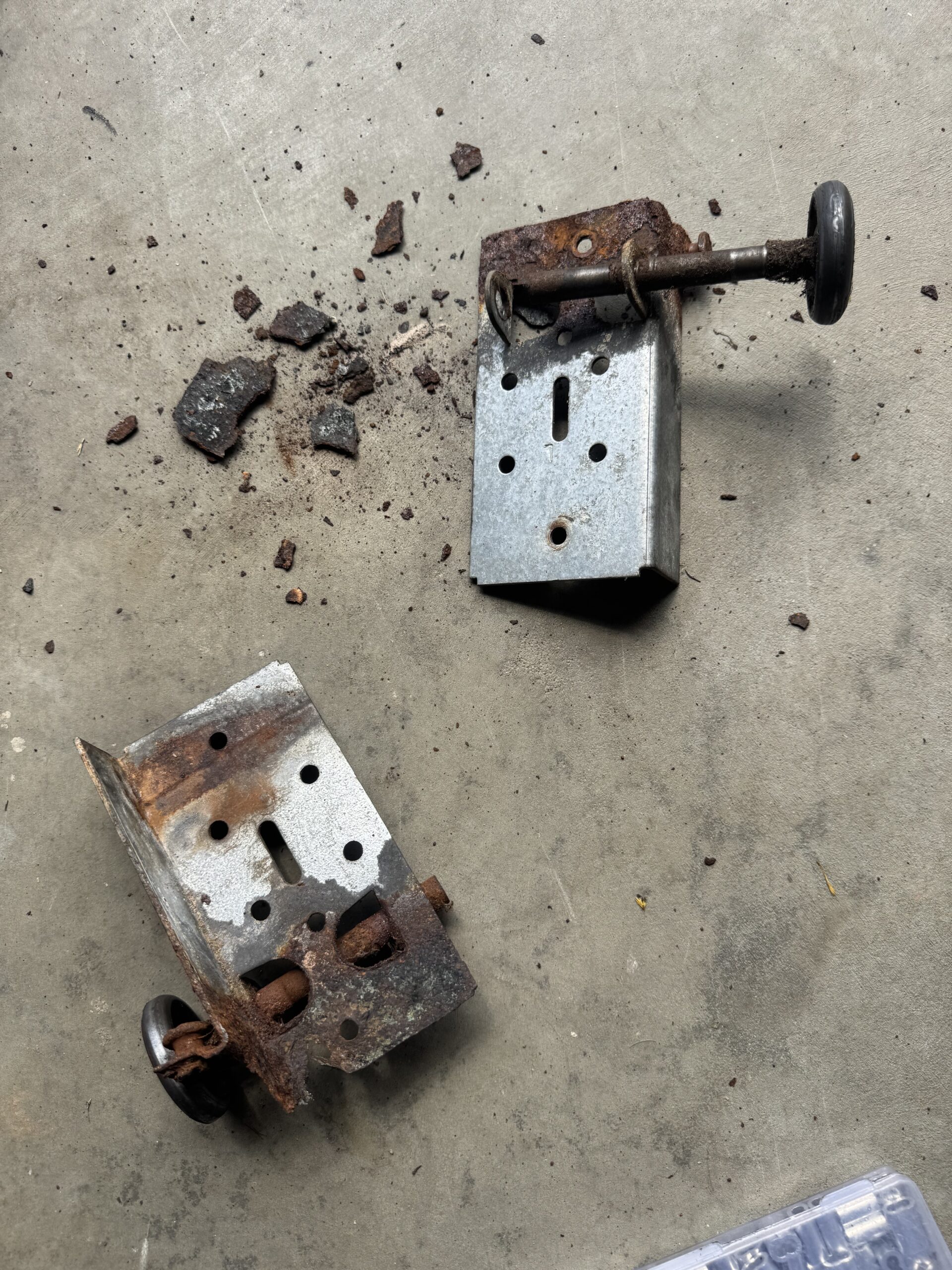 Damaged garage door bottom bracket removed during replacement in Vernon CT