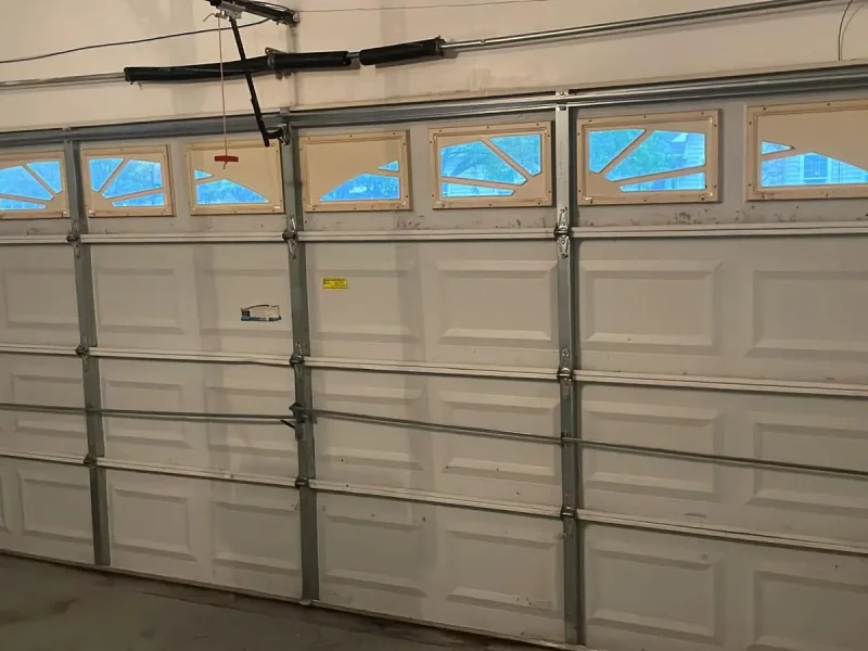 Skilled garage door technician from Bloomfield, CT performing a detailed safety inspection